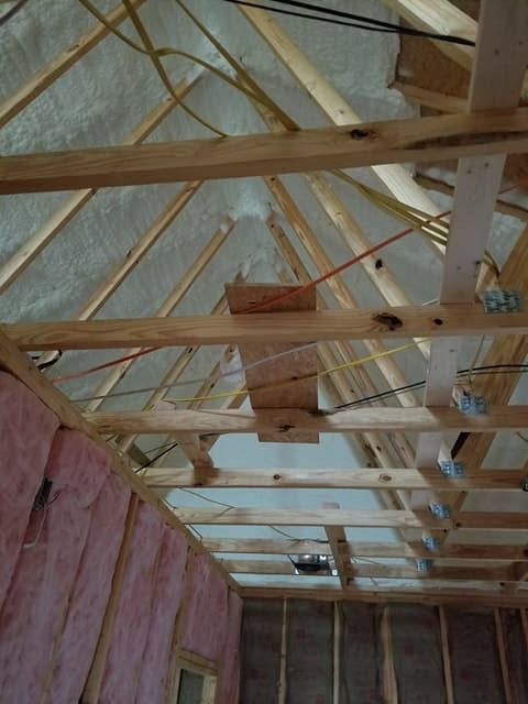Spray foam insulation covering an attic roof deck in a Jackson County home
